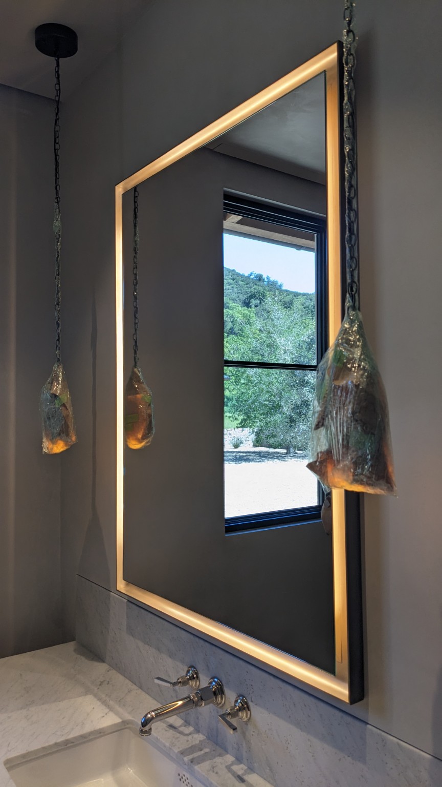 Illuminated bathroom mirror installation